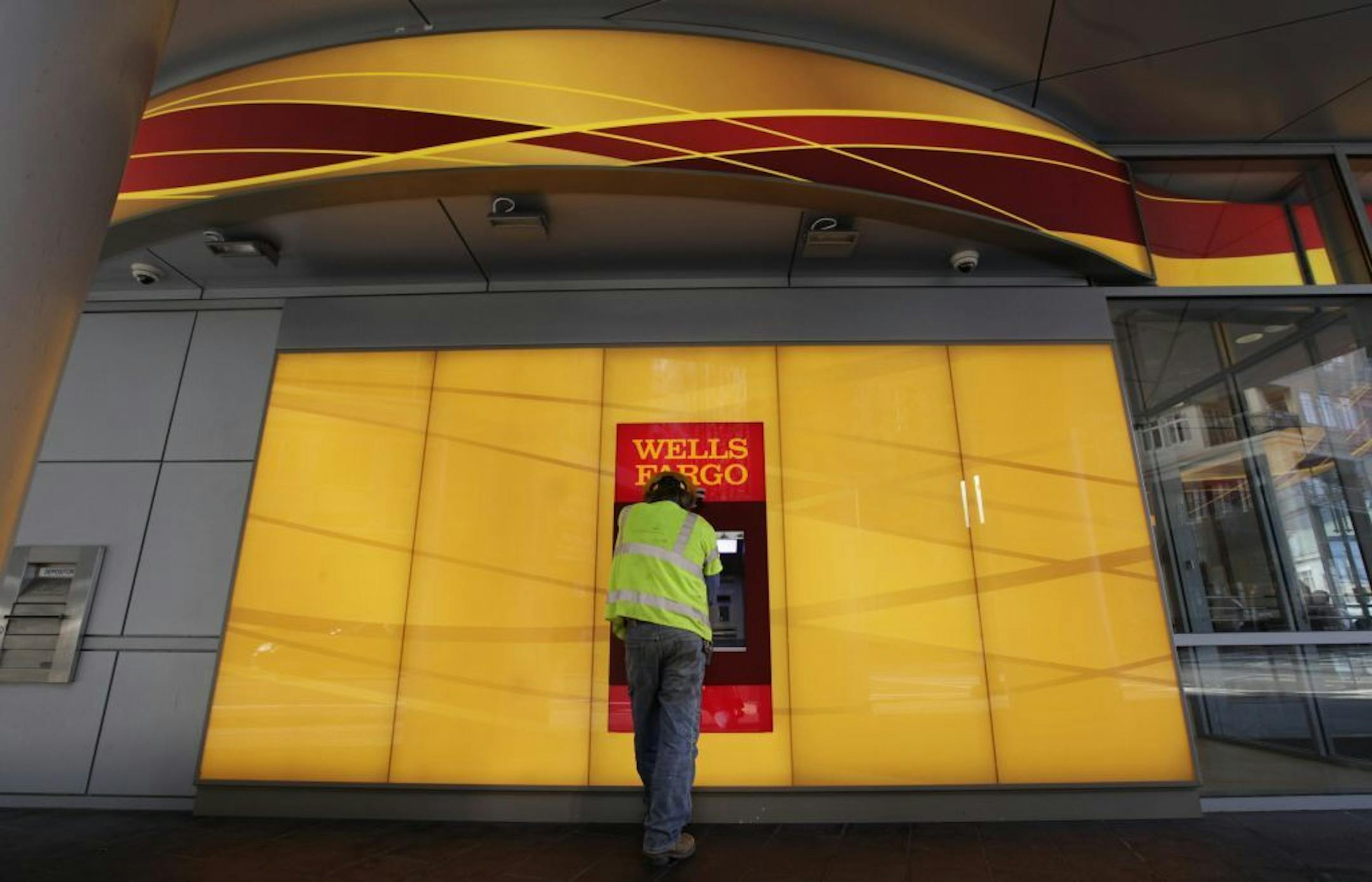 A customer uses an ATM outside a Wells Fargo branch in Charlotte, N.C., Tuesday, Jan. 17, 2012. Wells�Fargo & Co. reports their company earnings on Friday, July 12, 2013.