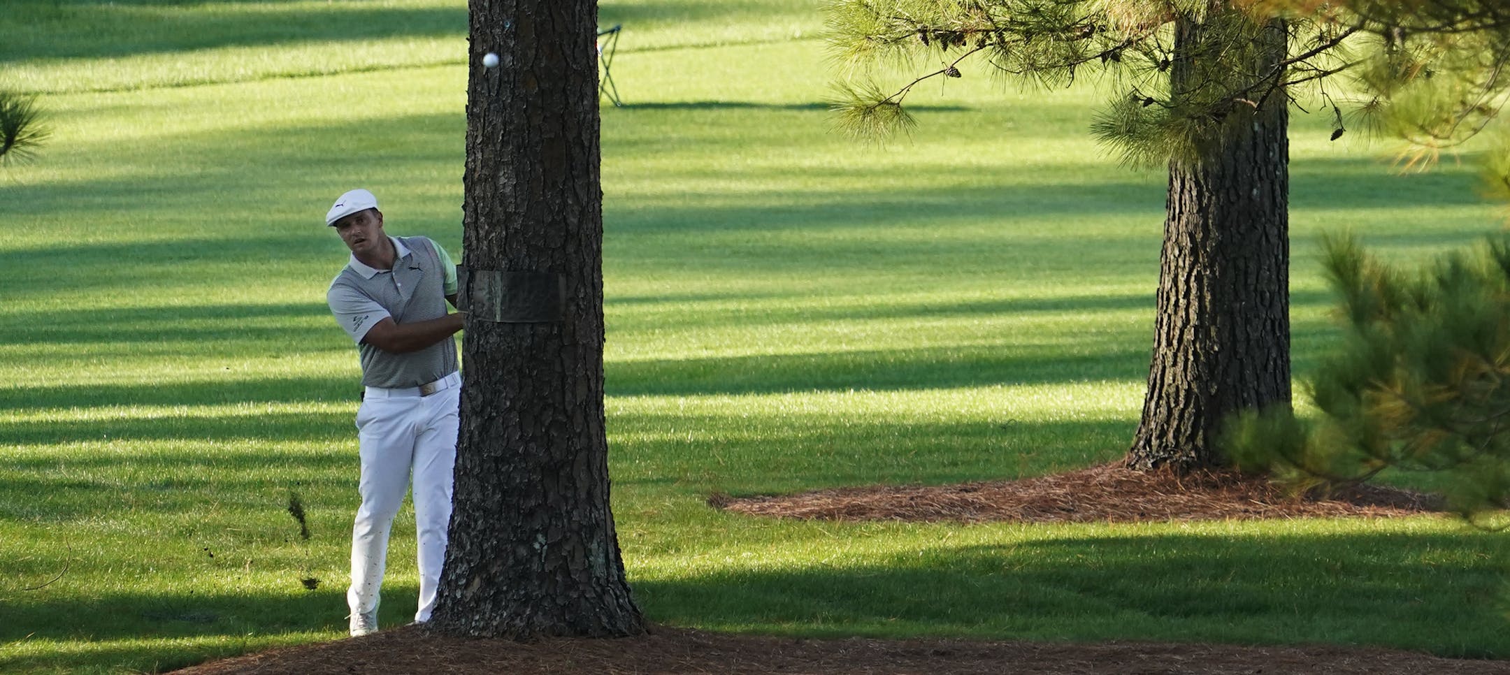 Bryson DeChambeau hits out of the rough on the seventh hole during the second round of the Masters golf tournament Friday, Nov. 13, 2020, in Augusta, Ga. (AP Photo/David J. Phillip)