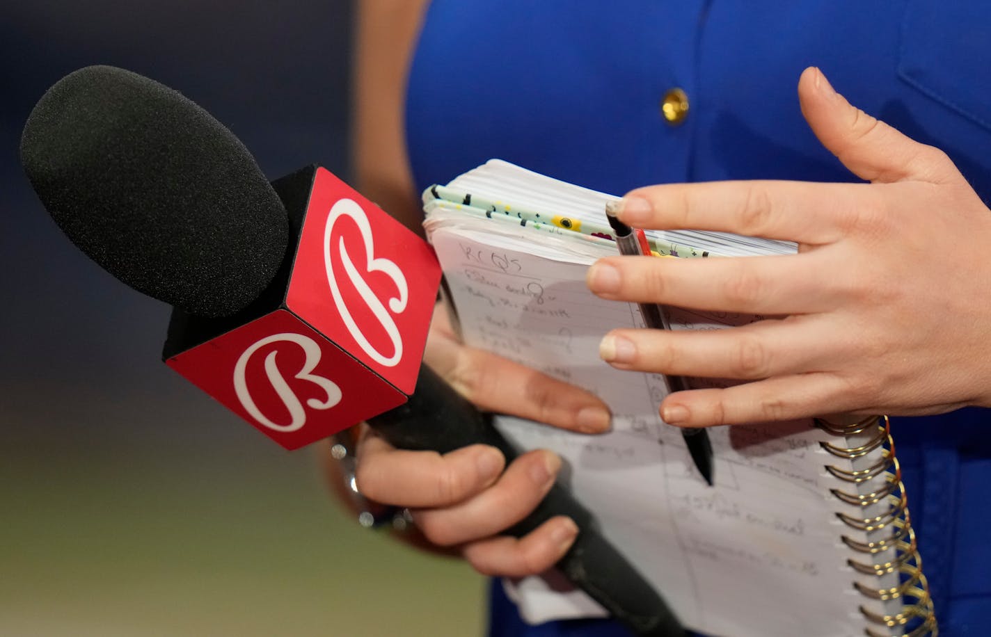 A Bally Sports reporter waits for an interview after a baseball game between the Tampa Bay Rays and the Minnesota Twins Tuesday, June 6, 2023, in St. Petersburg, Fla. (AP Photo/Chris O'Meara)