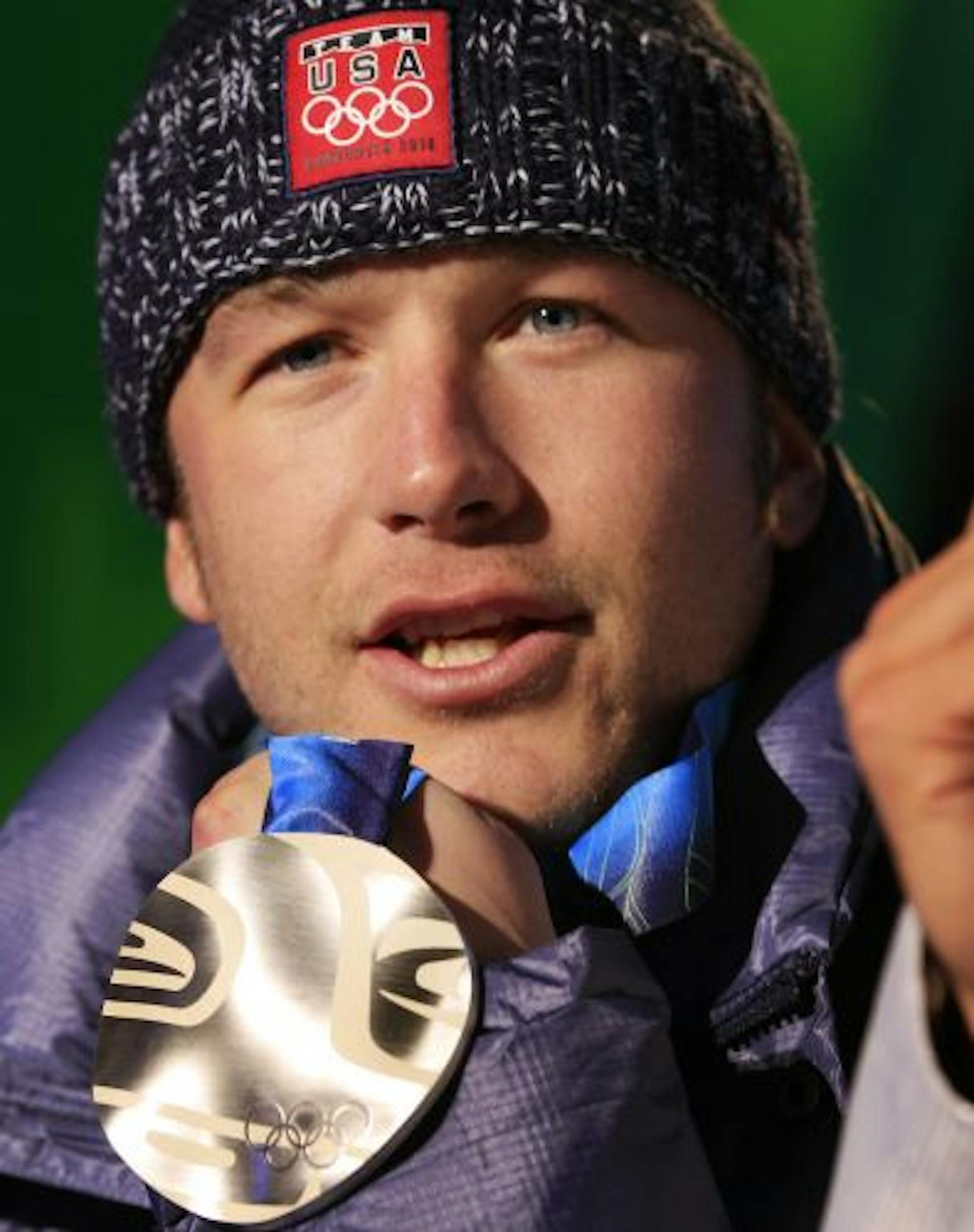 Silver medallist Bode Miller of the United States shows his medal during the medal ceremony for the men's super-G event at the Vancouver 2010 Olympics in Whistler, British Columbia, Friday, Feb. 19, 2010.