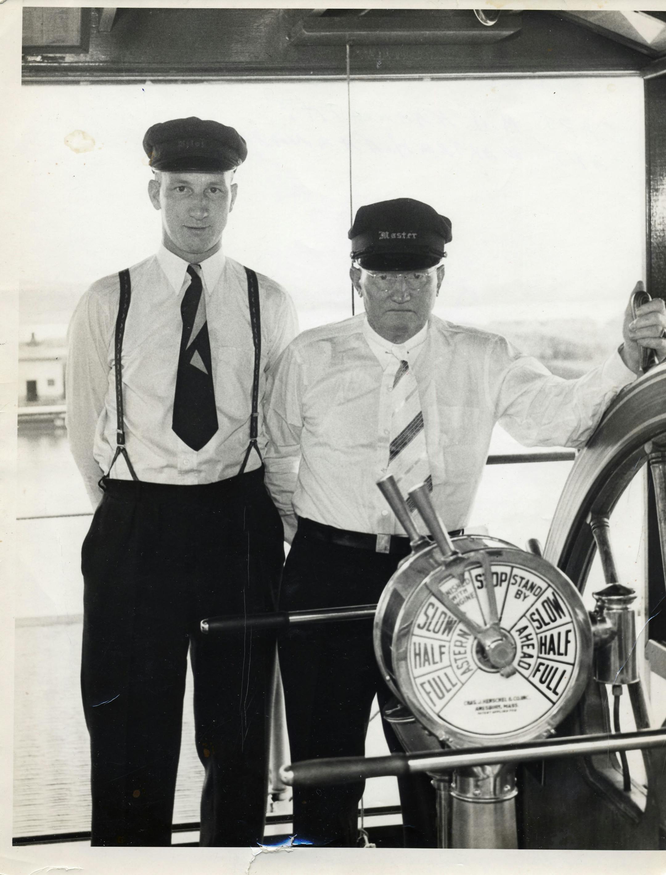 In a 1938 photograph provided by Dick Karnath, his dad, Capt. Walter Karnath, left, and grandfather, Capt. R. J. (Red) Karnath kept watch on the wheel of the coal-fired paddlewheel steamer General Allen.