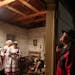 To get in the Holiday spirit, the New Prague Czech singers and several members of the New Prague High choir sang inside and outside the cabin Friday, 