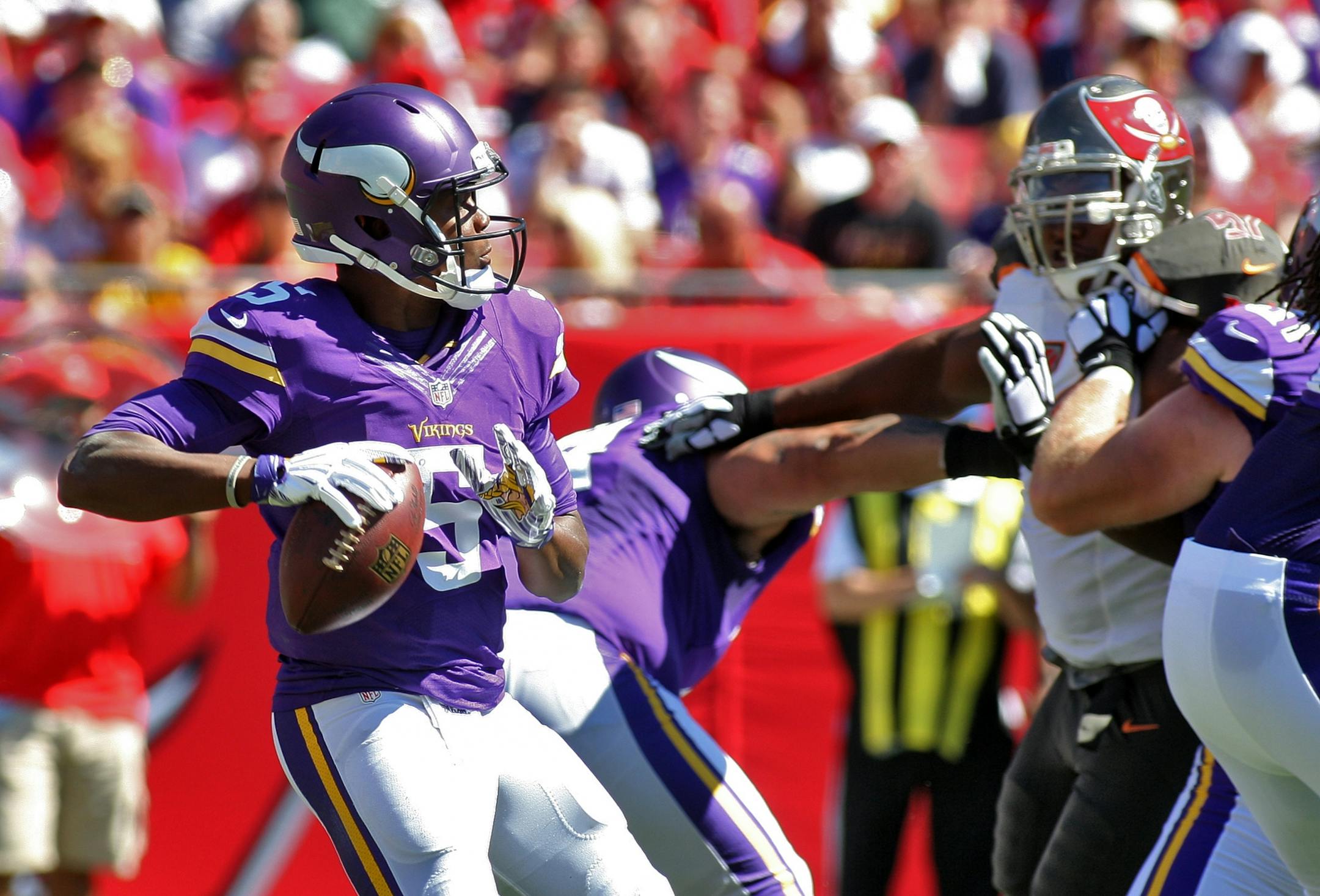 Minnesota Vikings quarterback Teddy Bridgewater (5) looks to pass as he is pressure by the Tampa Bay Buccaneers defense during the first quarter of an NFL football game Sunday, Oct. 26, 2014, in Tampa, Fla.