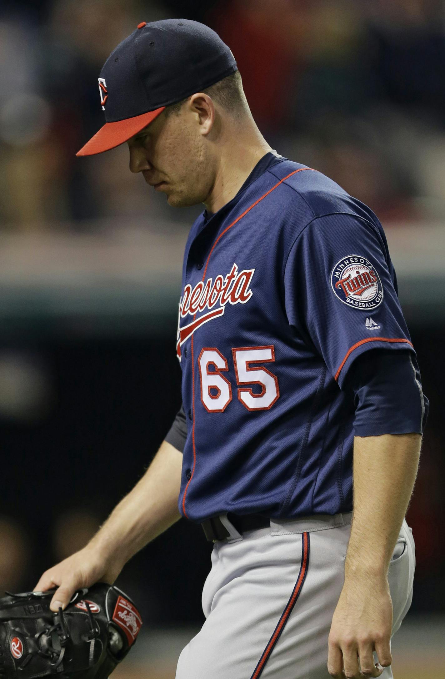 Minnesota Twins relief pitcher Trevor May walks to the dugout in the eighth inning of a baseball game against the Cleveland Indians, Friday, May 13, 2016, in Cleveland. (AP Photo/Tony Dejak) ORG XMIT: OHTD10