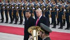 FILE -- President Donald Trump and President Xi Jinping of China at a welcome ceremony in Beijing, Nov. 9, 2017. Xi April 10, 2018, portrayed China as