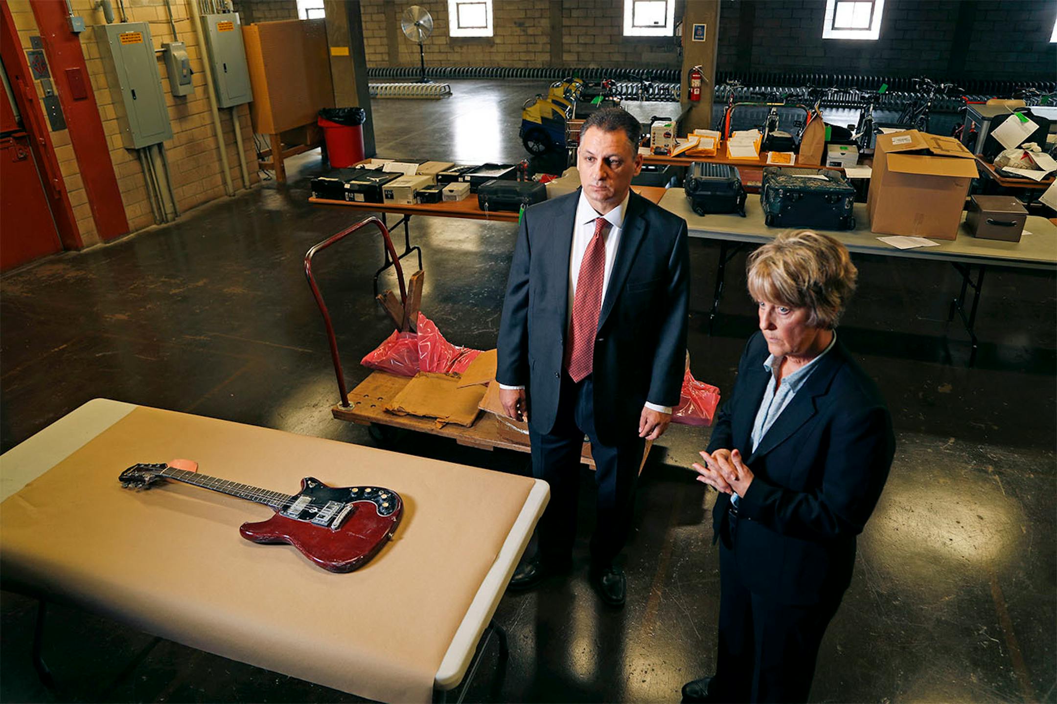 Members of the Minneapolis Cold Case Squad Sgt. Chris Karkostas left, and Sgt. Jane Moore talked about the unsolved murder of Joseph Behrend at the police department�s evidence warehouse Monday August 15, 2016 in Minneapolis, MN. The red Epiphone guitar is believed to be the murder weapon.