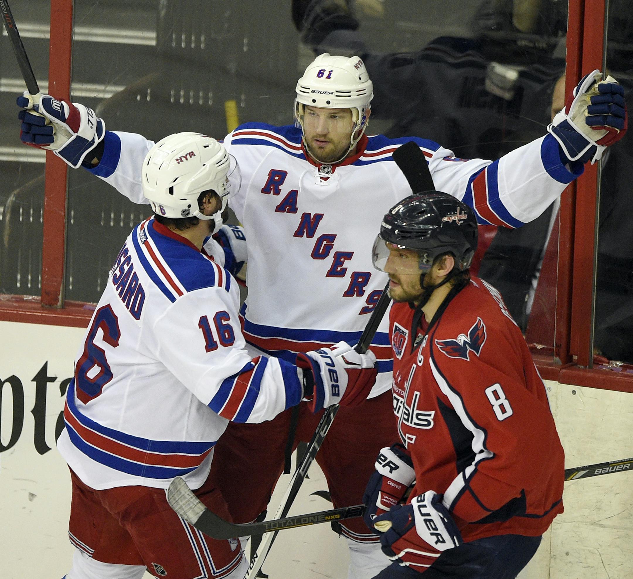 New York Rangers left wing Rick Nash (61) celebrates his goal with Derick Brassard (16) as Washington Capitals left wing Alex Ovechkin (8), from Russia, skates by during the third period of Game 6 in the second round of the NHL Stanley Cup hockey playoffs, Sunday, May 10, 2015, in Washington. The Rangers won 4-3. (AP Photo/Nick Wass)