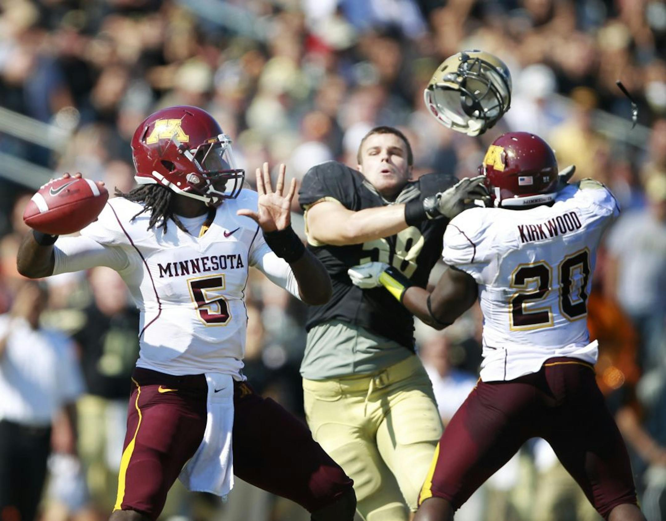 Minnesota quarterback MarQueis Gray threw a incomplete pass in the fourth quarter but got a good block from teammate Donnell Kirkwood knocking the helmet of Purdue's defensive end Robert Maci during Saturday October 8, 2011Big Ten action between Minnesota and Purdue at Ross-Ade Stadium in West Lafayette, Indiana. Purdue beat Minnesota 45-17.