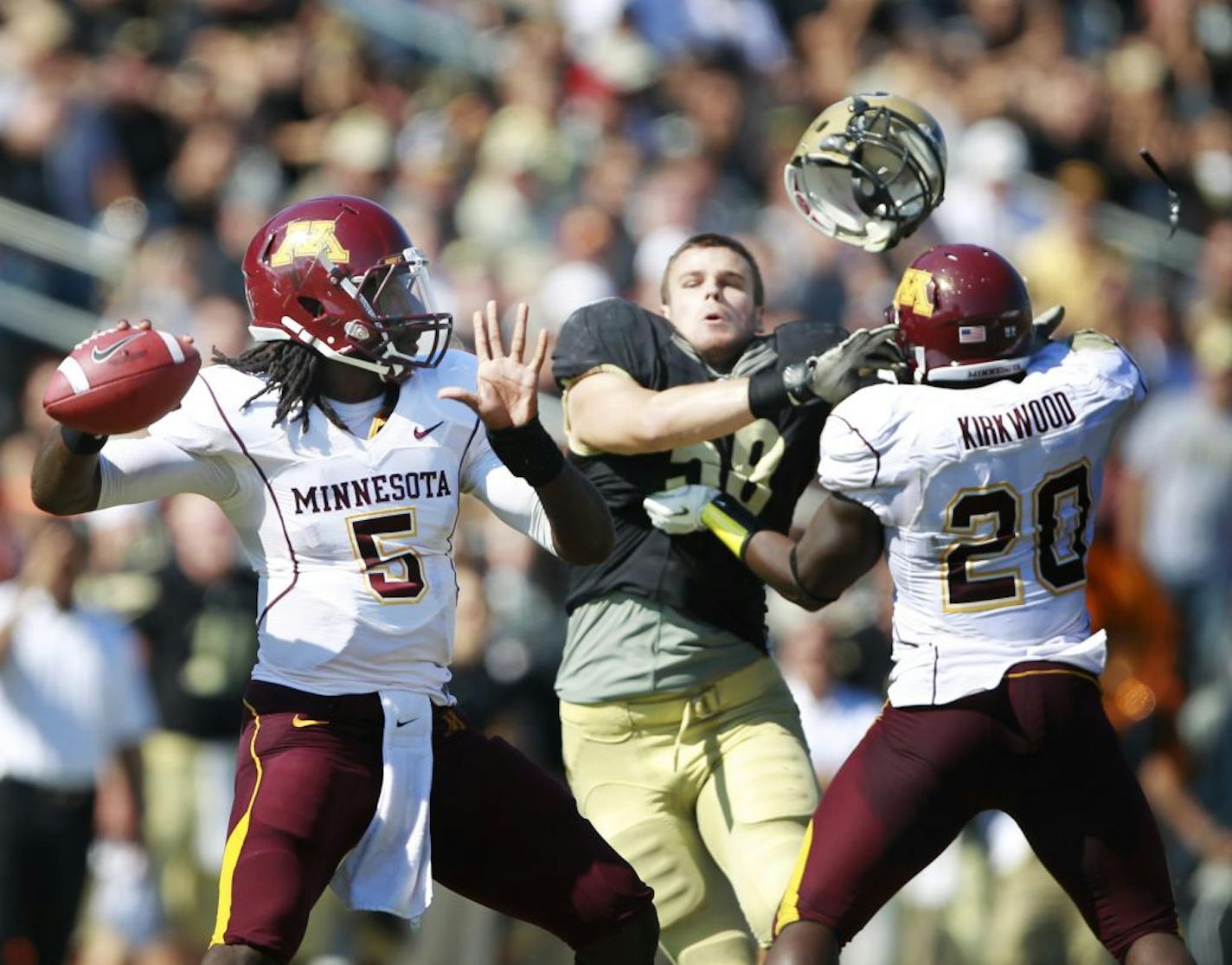 Minnesota quarterback MarQueis Gray threw a incomplete pass in the fourth quarter but got a good block from teammate Donnell Kirkwood knocking the helmet of Purdue's defensive end Robert Maci during Saturday October 8, 2011Big Ten action between Minnesota and Purdue at Ross-Ade Stadium in West Lafayette, Indiana. Purdue beat Minnesota 45-17.