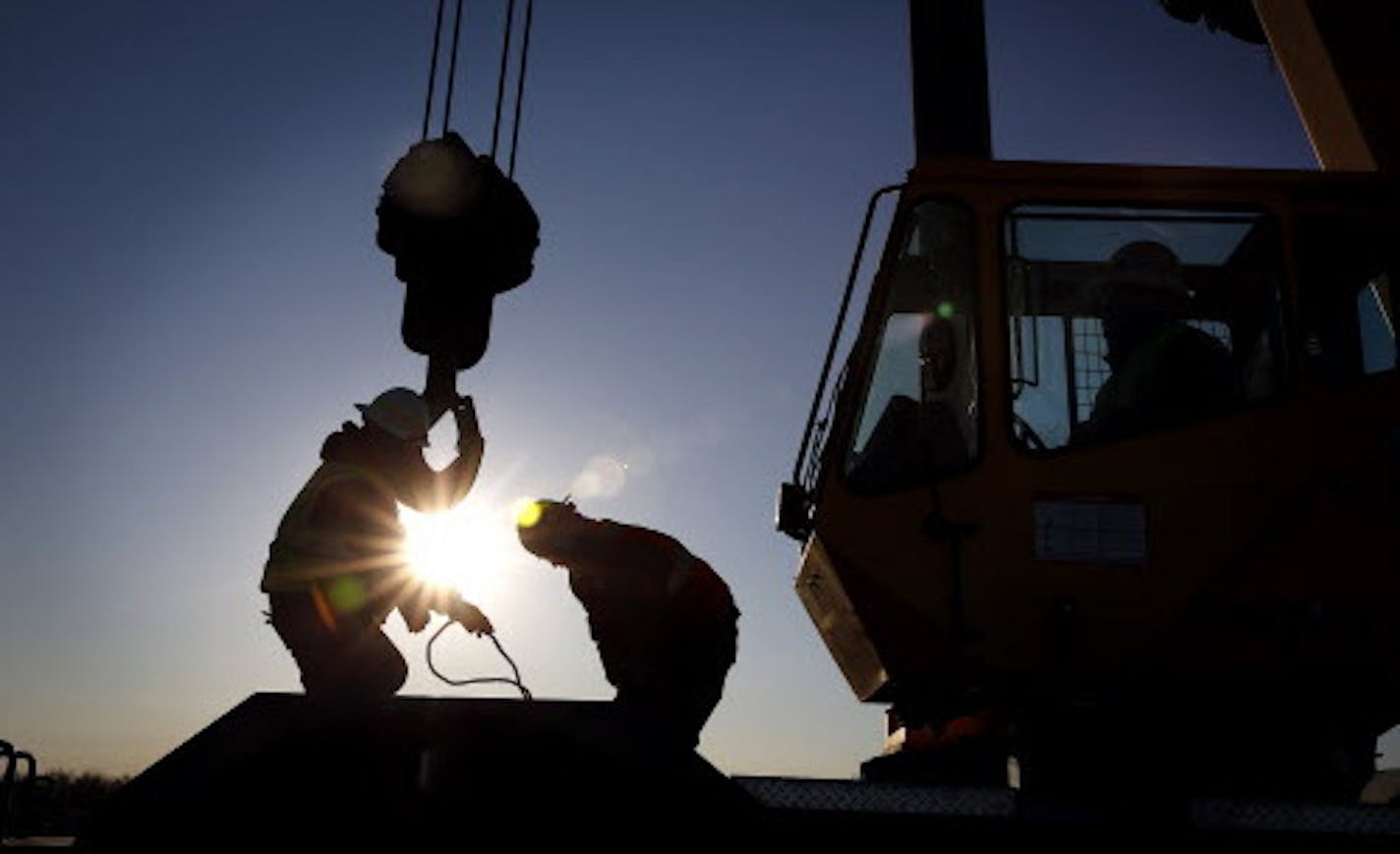 Iron workers set up a crane to move steel for the construction of buildings on the site of Essar Steel Minnesota's taconite mine project in Nashwauk, Minn.