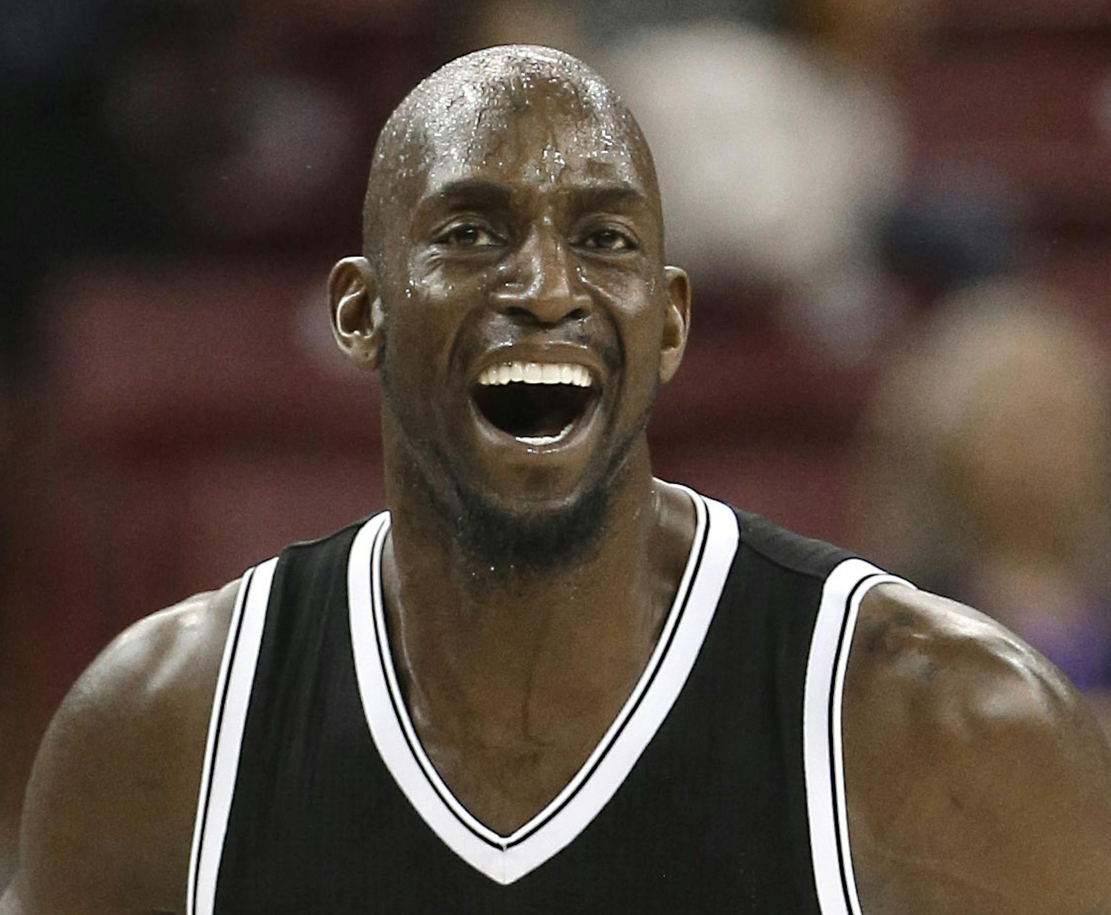 Brooklyn Nets forward Kevin Garnett smiles as he runs down the court after scoring against the Sacramento Kings during the third quarter of an NBA basketball game in Sacramento, Calif., Wednesday, Jan. 21, 2015. The Nets won 103-100. (AP Photo/Rich Pedroncelli) ORG XMIT: MIN2015022421040689