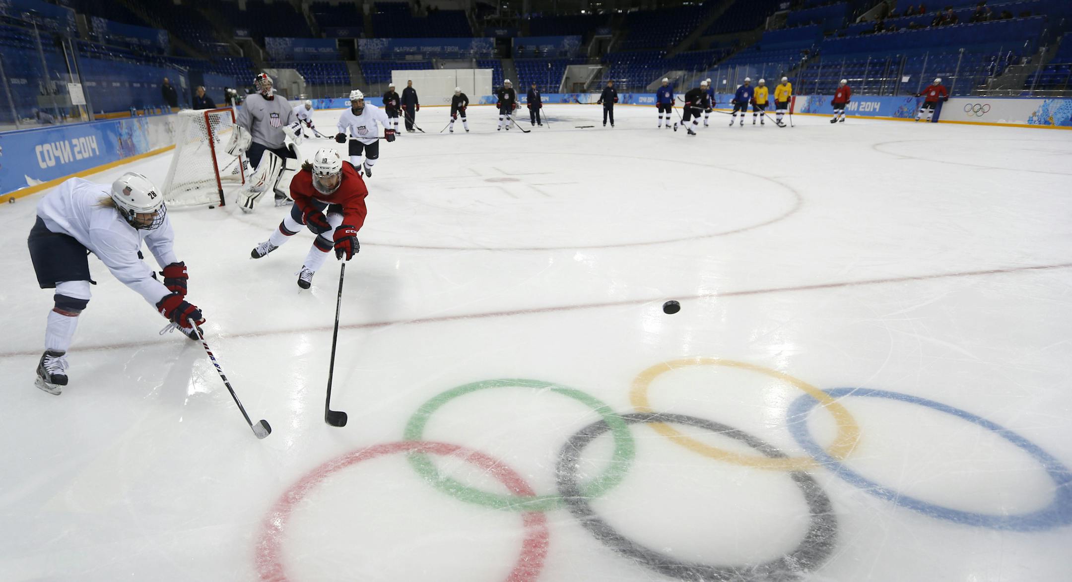 Meghan Duggan, right, of the U.S. women's ice hockey team challenges her teammate Amanda Kessel, left, during their practice session ahead of the 2014 Winter Olympics, Thursday, Feb. 6, 2014, in Sochi, Russia. (AP Photo/Petr David Josek)