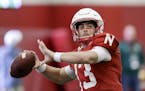 FILE - In this March 11, 2017, file photo, Nebraska quarterback Tanner Lee (13) throws during NCAA college football spring practice in Lincoln, Neb. A