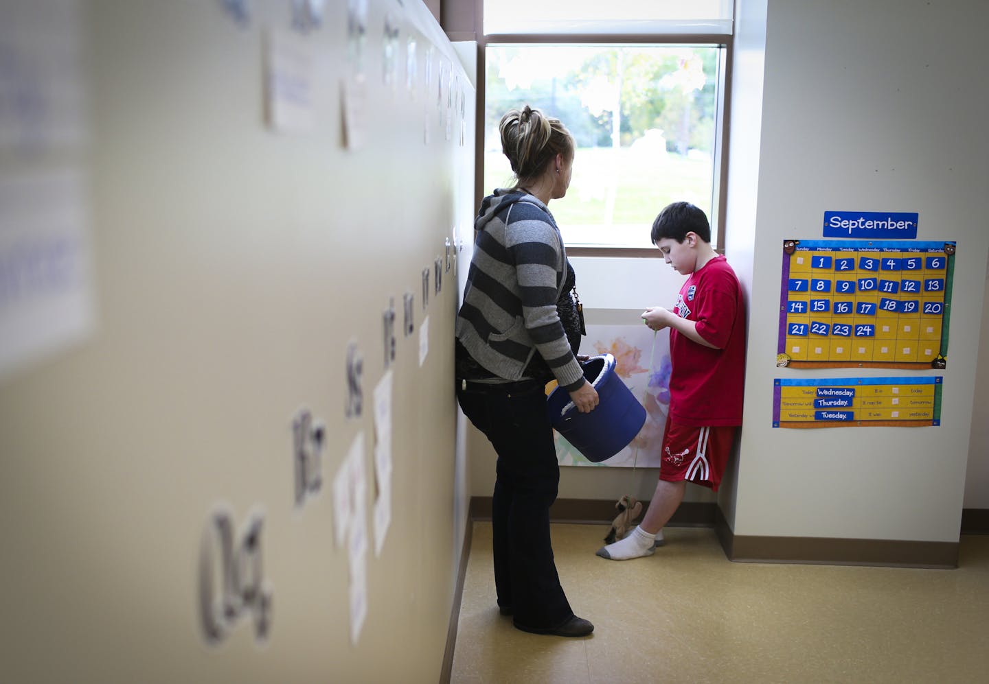 Autism specialist Megan Halverson talked with Tyler Hawley, who took a break in the corner of a classroom Wednesday at Karner Blue school for students with special needs in Blaine.