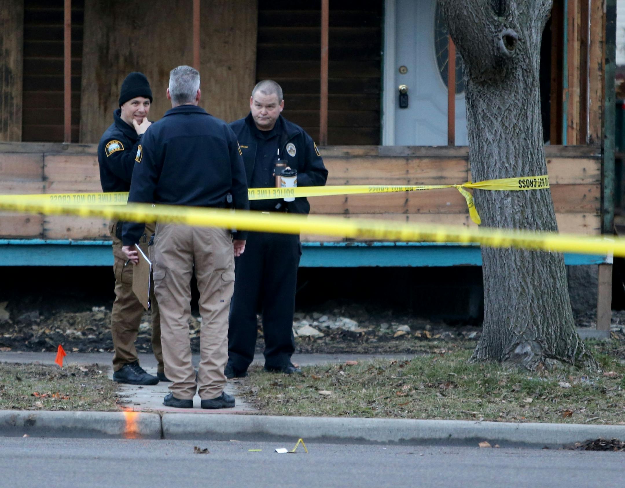 Scene of an early morning homicide where two persons are dead and a third critically wounded near the Salvation Army at 7th St and Smith Ave. Thursday, Dec. 10, 2015, in St. Paul, MN. Here, St. Paul police officers talk near Douglas and 7th Street while investigating the scene.