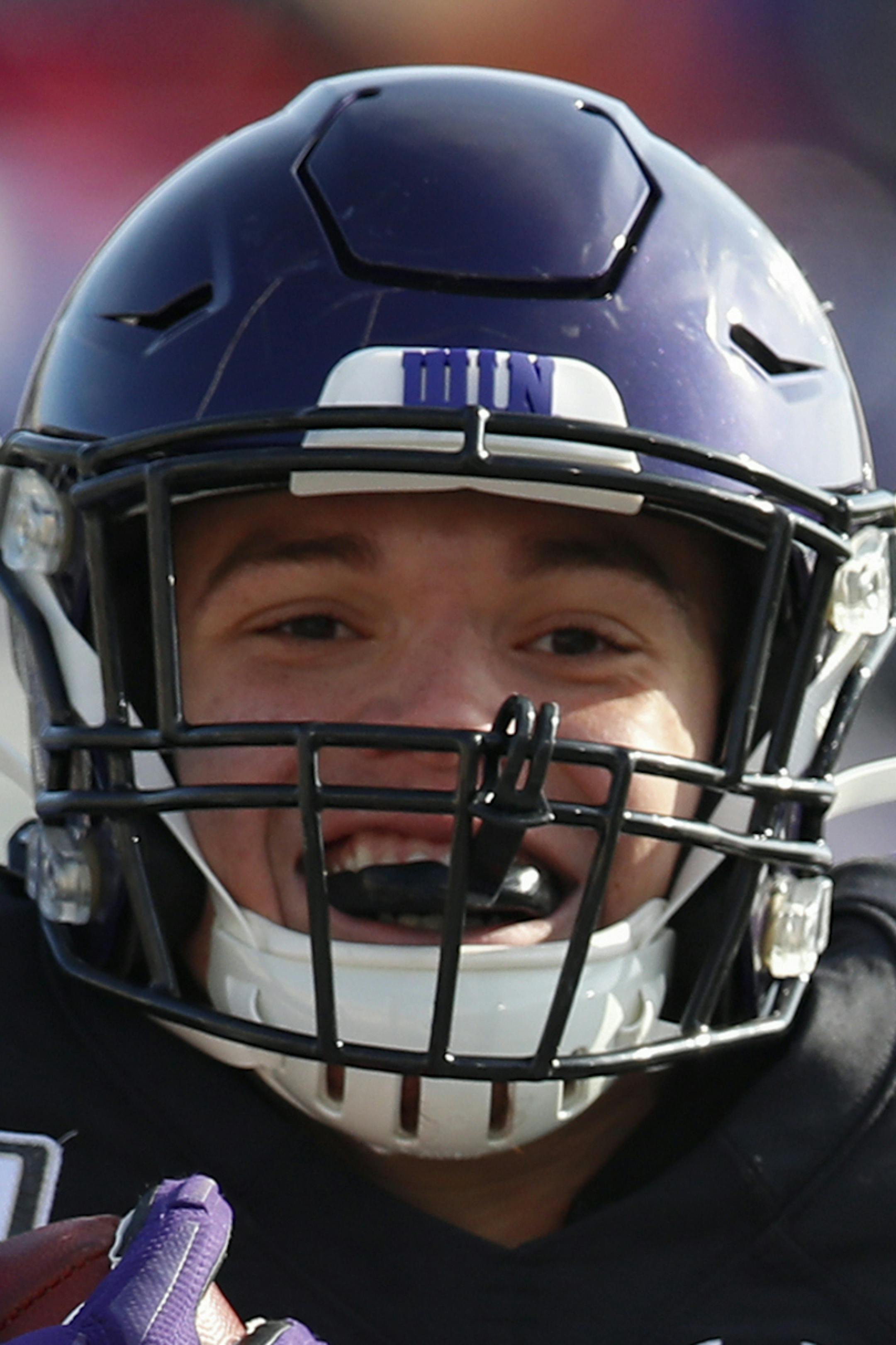 Northwestern's Evan Hull, center, celebrates as he scores a touchdown past Massachusetts' Isaiah Rodgers, left, and Massachusetts' Logan Darby during the first half of an NCAA college football game Saturday, Nov. 16, 2019, in Evanston, Ill. (AP Photo/Jim Young)