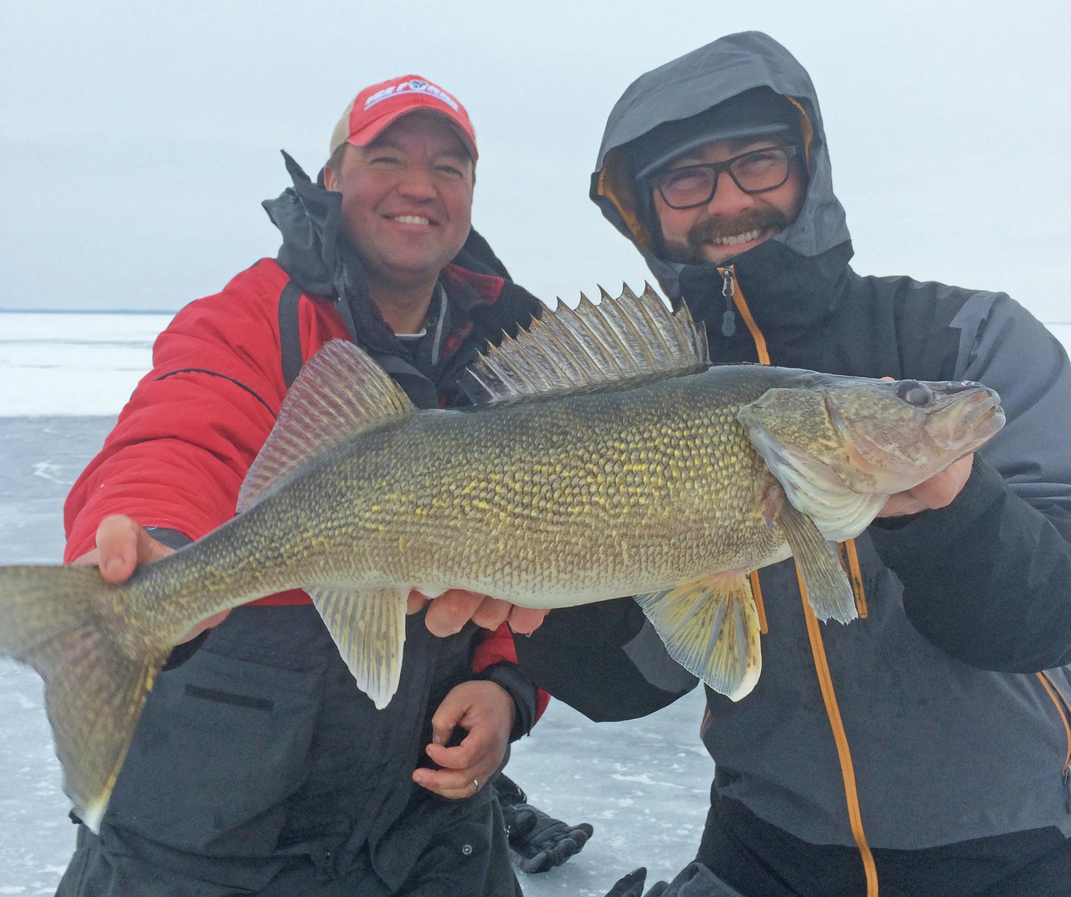Guide Tony Roach, left, and client John Bradley show of a monster walleye caught this winter on Mille Lacs.