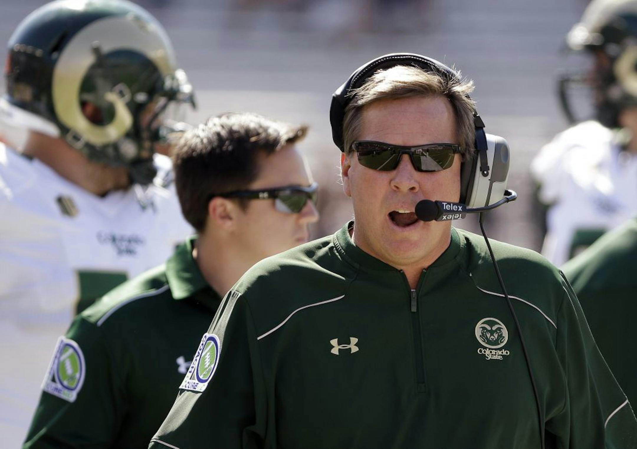 FILE - In this Sept. 27, 2014, file photo, Colorado State head coach Jim McElwain talks in his headset during the first quarter of an NCAA college football game against Boston College in Boston. A person familiar with the search says Florida has hired McElwain as its next football coach. The person spoke to The Associated Press on Thursday, Dec. 4, 2014, on the condition of anonymity because the Gators have not announced details of their coaching search. The person says McElwain officially accep