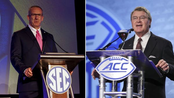 FILE - At left, in a July 10, 2017, file photo, SEC�conference commissioner Greg Sankey speaks during the NCAA college football Southeastern Confere