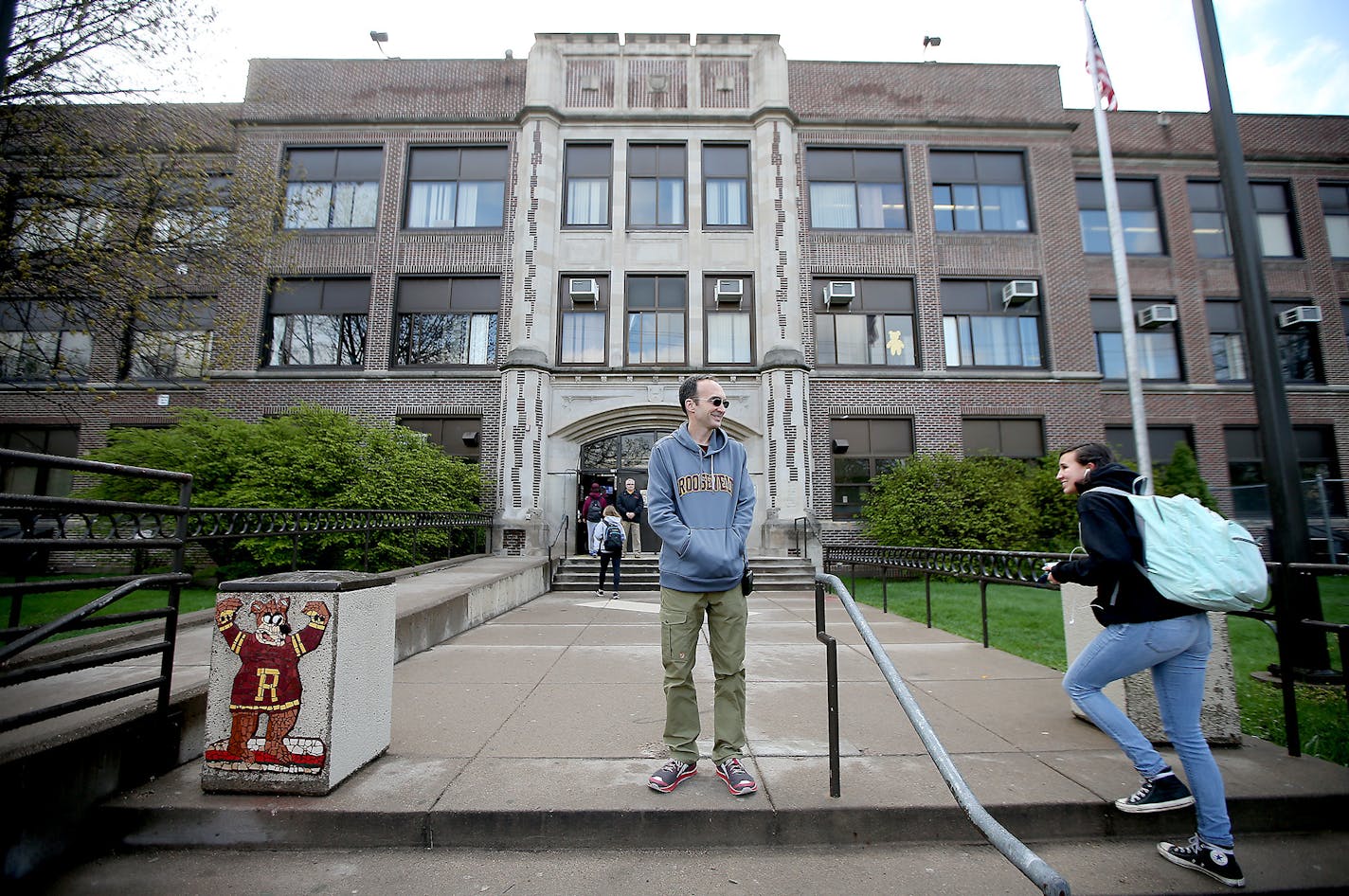 Roosevelt High School Principal Michael Bradley greeted students as they made their way into school, Friday, April 29, 2016 in Minneapolis, MN. Bradley became the principal of Roosevelt High in 2011. Since then, more students are choosing to go to the school, in particular Latino and other immigrant high schoolers who feel the school embraces their culture. The school also saw a dramatic increase in graduation rates, but it still remains one of the district's lowest performing high schools. ] (E