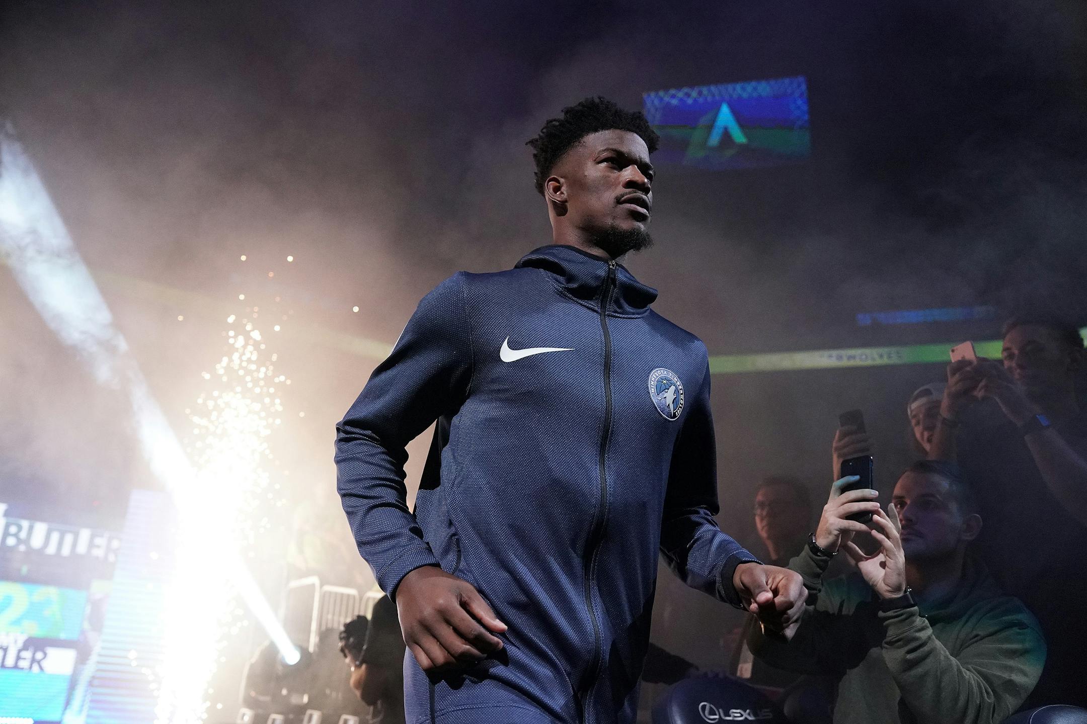 Timberwolves guard Jimmy Butler takes the court to a mixture of cheers and boos prior to action against the Cavaliers