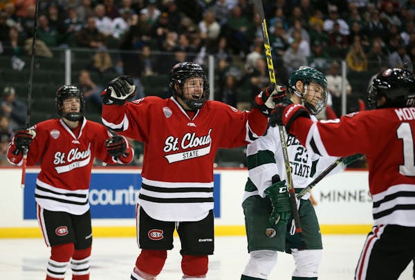 St. Cloud State forward Joey Benik, center, celebrated his first-period goal against Bemidji State in the North Star College Cup championship game at 
