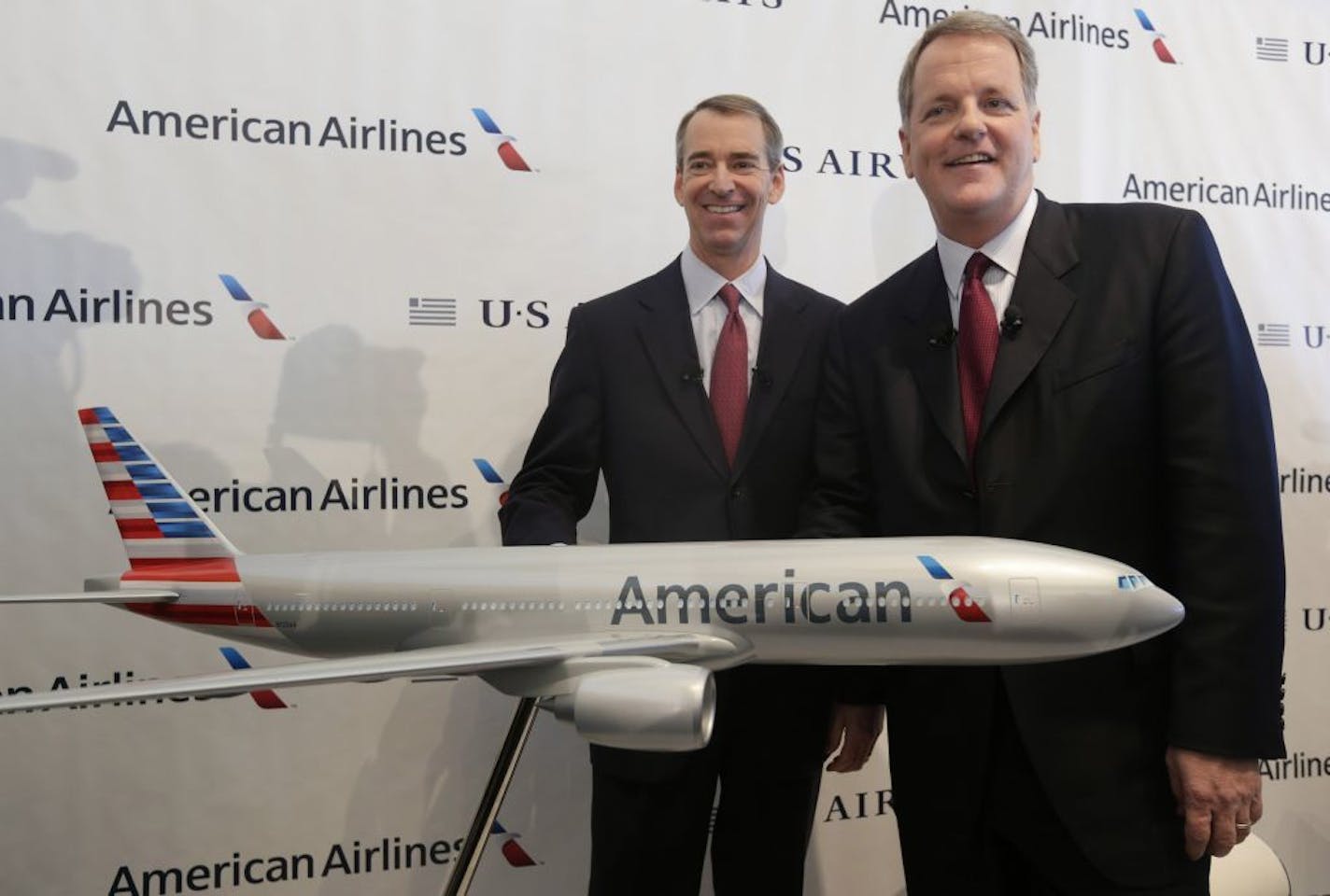 U.S. Airways CEO Doug Parker, right, and American Airlines CEO Tom Horton pose after a news conference at DFW International Airport Thursday, Feb. 14, 2013, in Grapevine, Texas. The two airlines will merge forming the world's largest airlines.