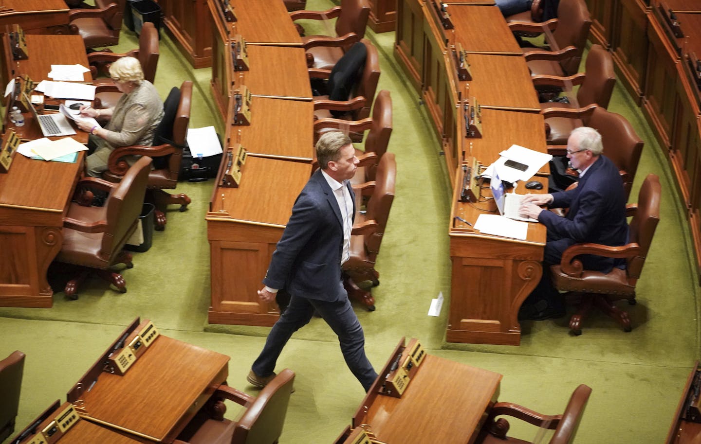 House Minority Leader Kurt Daudt, R-Crown walks out of the House Chamber Sunday, May 17, 2020 not wearing a mask, in St. Paul. All the DFL legislators choose to wear a mask on the House floor and all the Republican legislators choose not to wear masks on the floor. (Glen Stubbe/Star Tribune via AP)