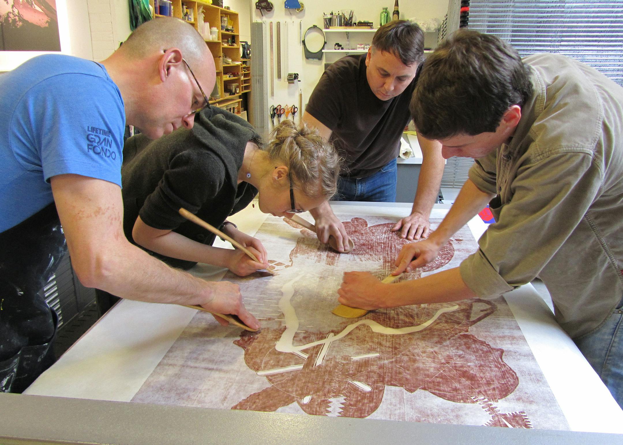 Highpoint Center for Printmaking Working on an Aaron Spangler print at Highpoint. Spangler is third from left (black t-shirt)