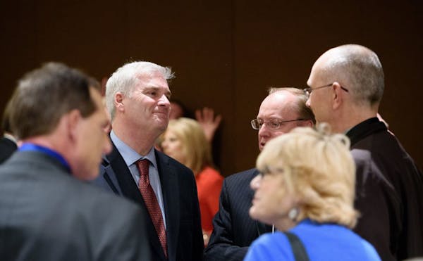 Congressman Tom Emmer, left, hosted a reception at the GOP convention and talked with first district congressional candidate Jim Hagedorn, center.