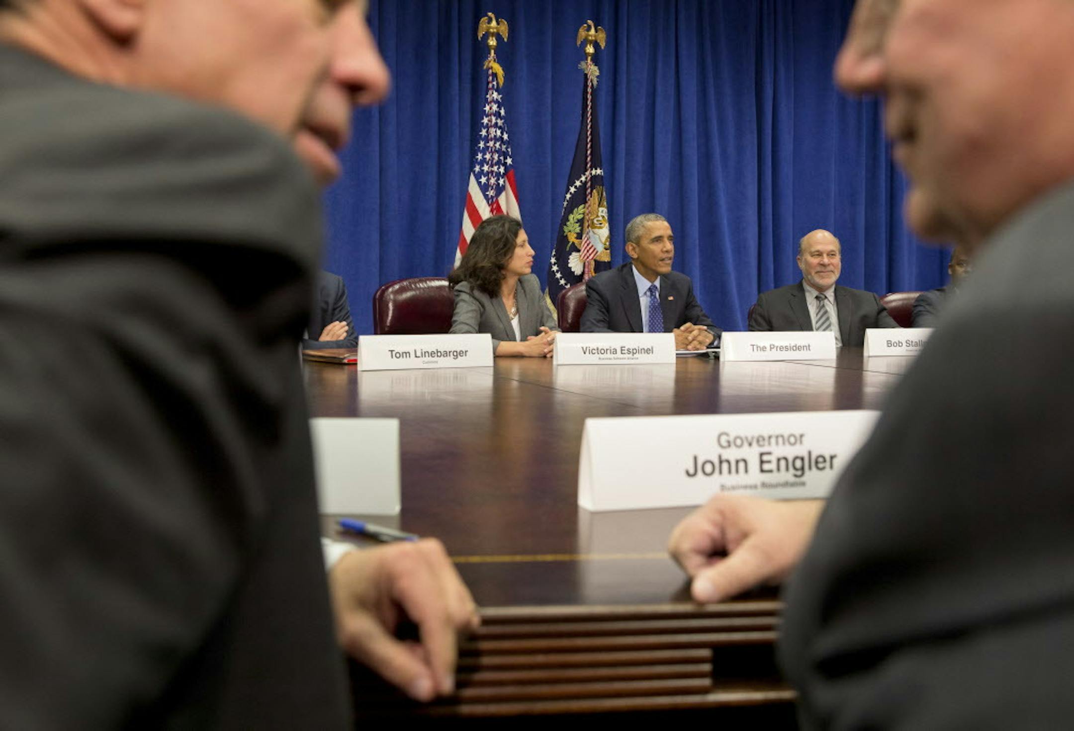 President Barack Obama sits next to Victoria Espinel, left, president and chief executive of the software industry trade group BSA, and Bob Stallman, right, president of the American Farm Bureau Federation, during a meeting with business leaders where the Trans-Pacific Partnership trade deal was discussed, at the Department of Agriculture in Washington, Oct. 6, 2015. Also pictured, in foreground, is: Arne Sorenson, left, president and chief executive of Marriott International and former Gov. Joh