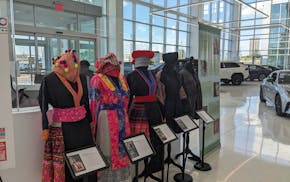 Mannequins adorned with various dresses from the Hmong diaspora are on view at Walser dealerships in the Minneapolis suburbs.