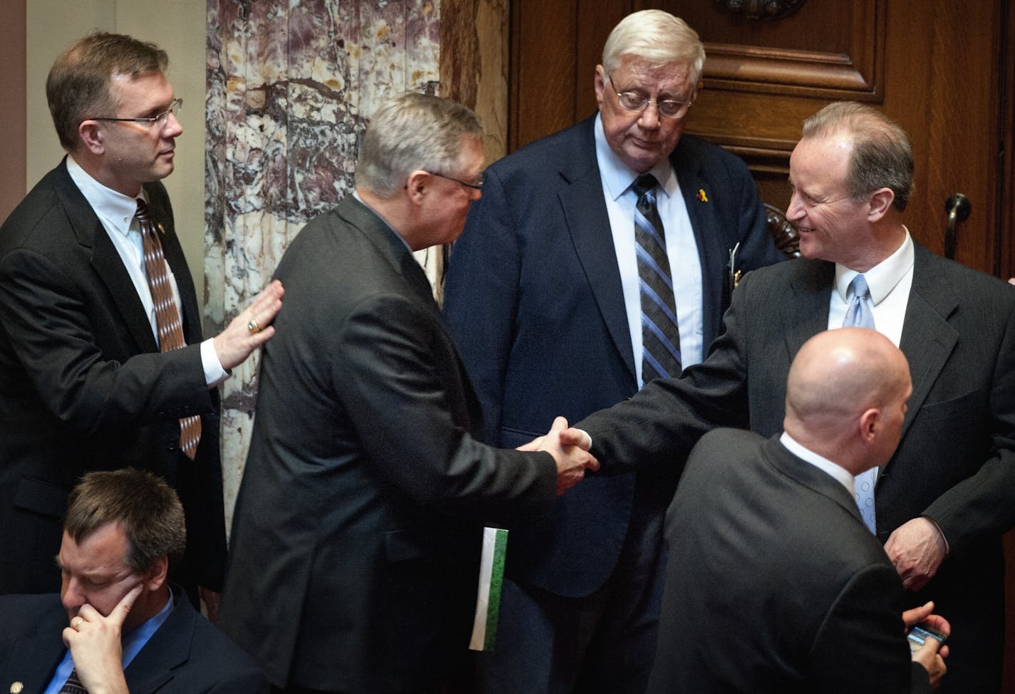 Sen. Scott Newman, second from left, who sponsored the bill in the Senate, received congratulations from GOP colleagues after it was passed.