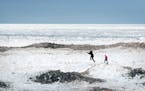 As waves of ice piled up Wednesday on Duluth's Park Point along the shore of Lake Superior, Cass, 8, and Eva, 4, took a break from a nine-hour drive f