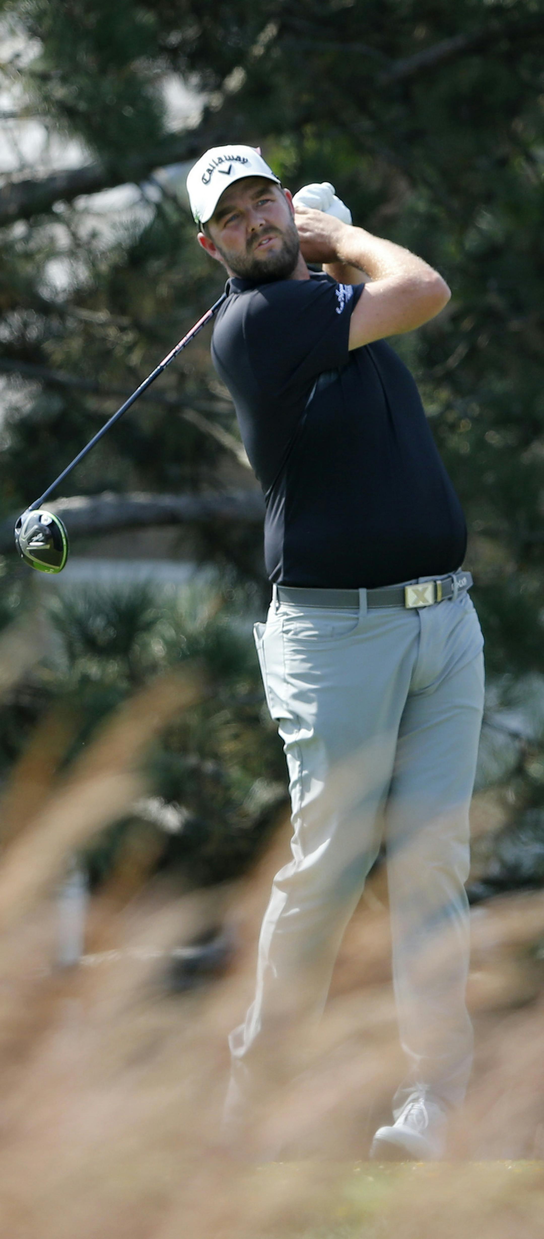Marc Leishman watches his tee shot on the fourth hole during the third round of the BMW Championship golf tournament at Conway Farms Golf Club, Saturday, Sept. 16, 2017, in Lake Forest, Ill. (AP Photo/Charles Rex Arbogast)
