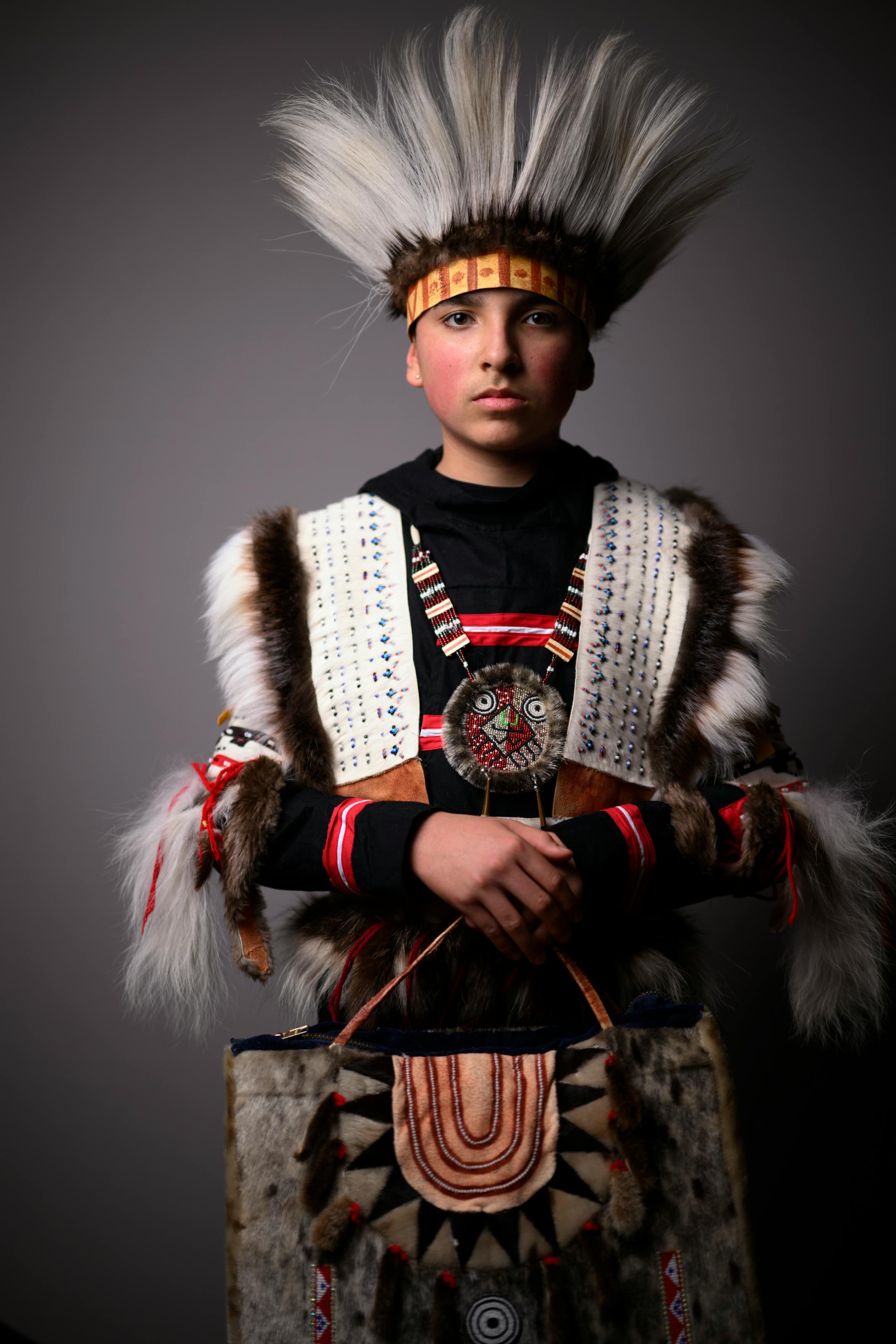 Deer River student Anthony Rivera, from Bena on the Leech Lake Reservation, stands for a portrait wearing fashion from artist Yup'ik artist Golga Oscar during the  "Northern Lights: A Native Nations Fashion Night."