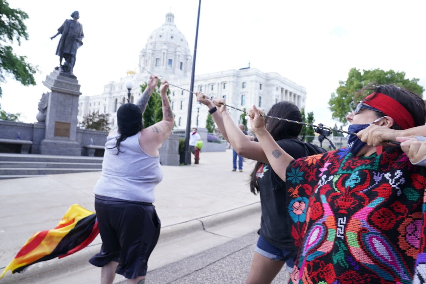 Activists bring down the Christopher Columbus statue on the grounds of the Minnesota State Capitol in St. Paul on Wednesday.