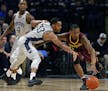 Penn State's Shepp Garner (33) goes for the steal on Minnesota's Deividas Zemgulis (1) during the first half of an NCAA college basketball game in Sta