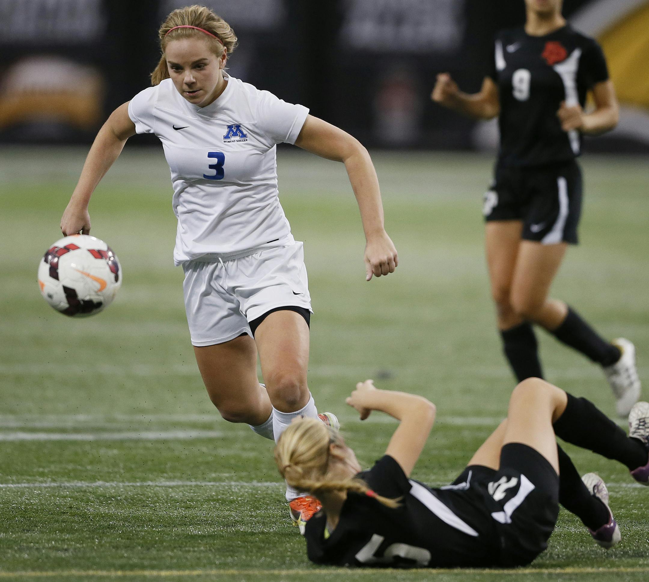 Minnetonka's Maggie Crist kicked the ball past Eden Prairie's Brooke Demets during class 2AA girls soccer action at the metro dome between Eden Prairie and Minnetonka Tuesday October 29, 2013 in Minneapolis, MN. Minnetonka beat Eden Prairie 3-2 in double overtime JERRY HOLT ‚Ä¢ jerry.holt@startribune.com