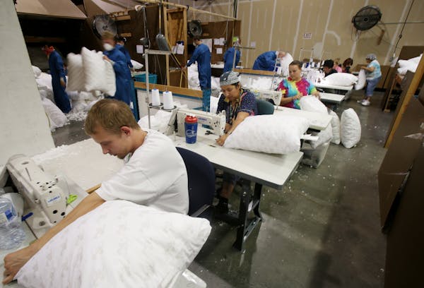 In this file photo, workers at MyPIllow fabricate pillows in Shakopee.