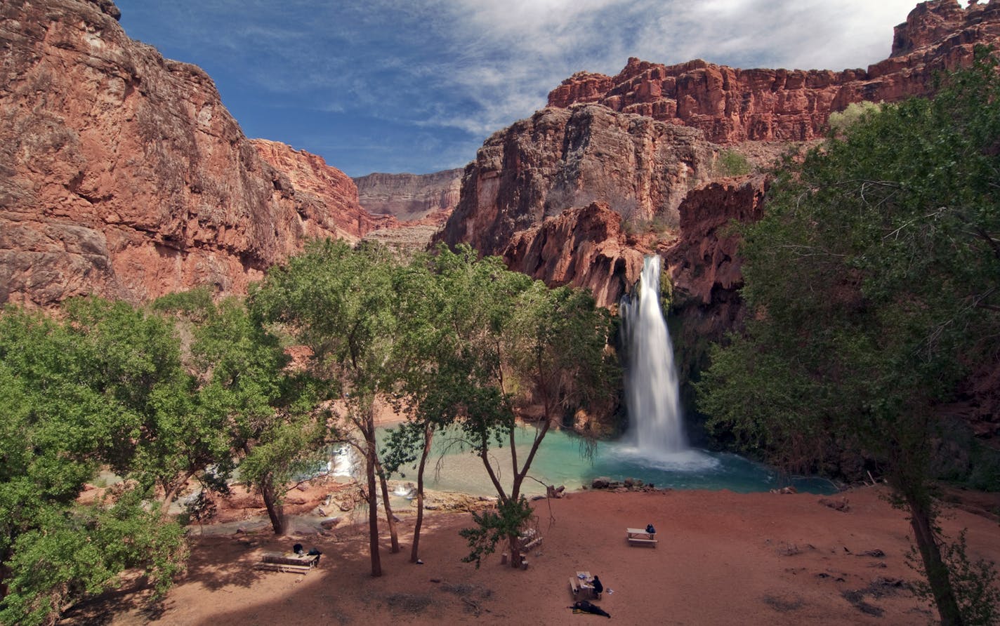 Campers picnic at the base of Havasu Falls, one of several waterfalls in the Grand Canyon&#x201a;&#xc4;&#xf4;s Havasupai Indian Reservation. Photo by Julie Quarry.