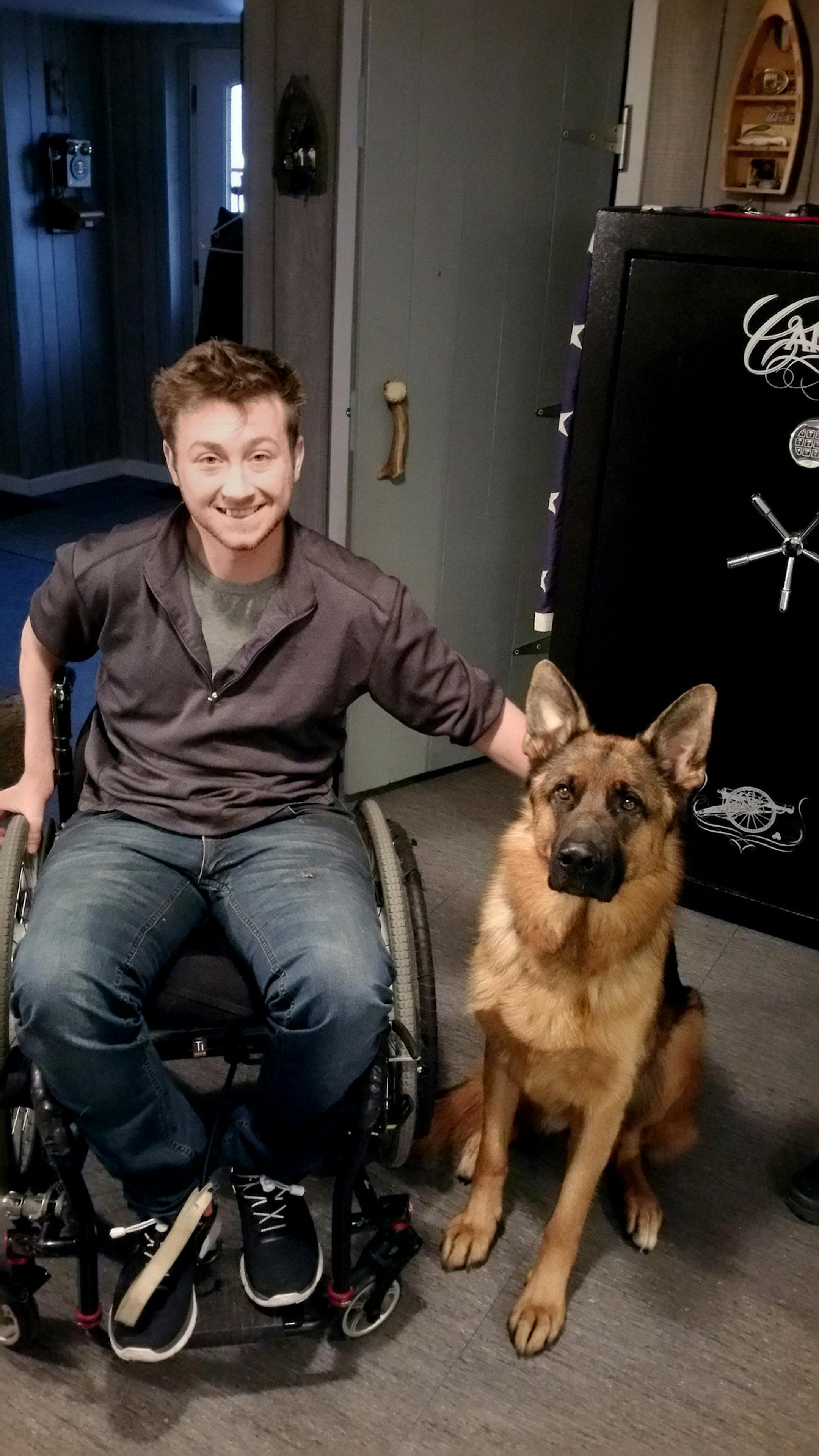 Michael Fraser, 24, of Vandergrift, who has quadriplegia but underwent experimental stem-cell surgery that succeeded in improving upper-body muscle function and strength. The dog is his service animal. Photo courtesy of Cori Fraser This goes with StemCells0226