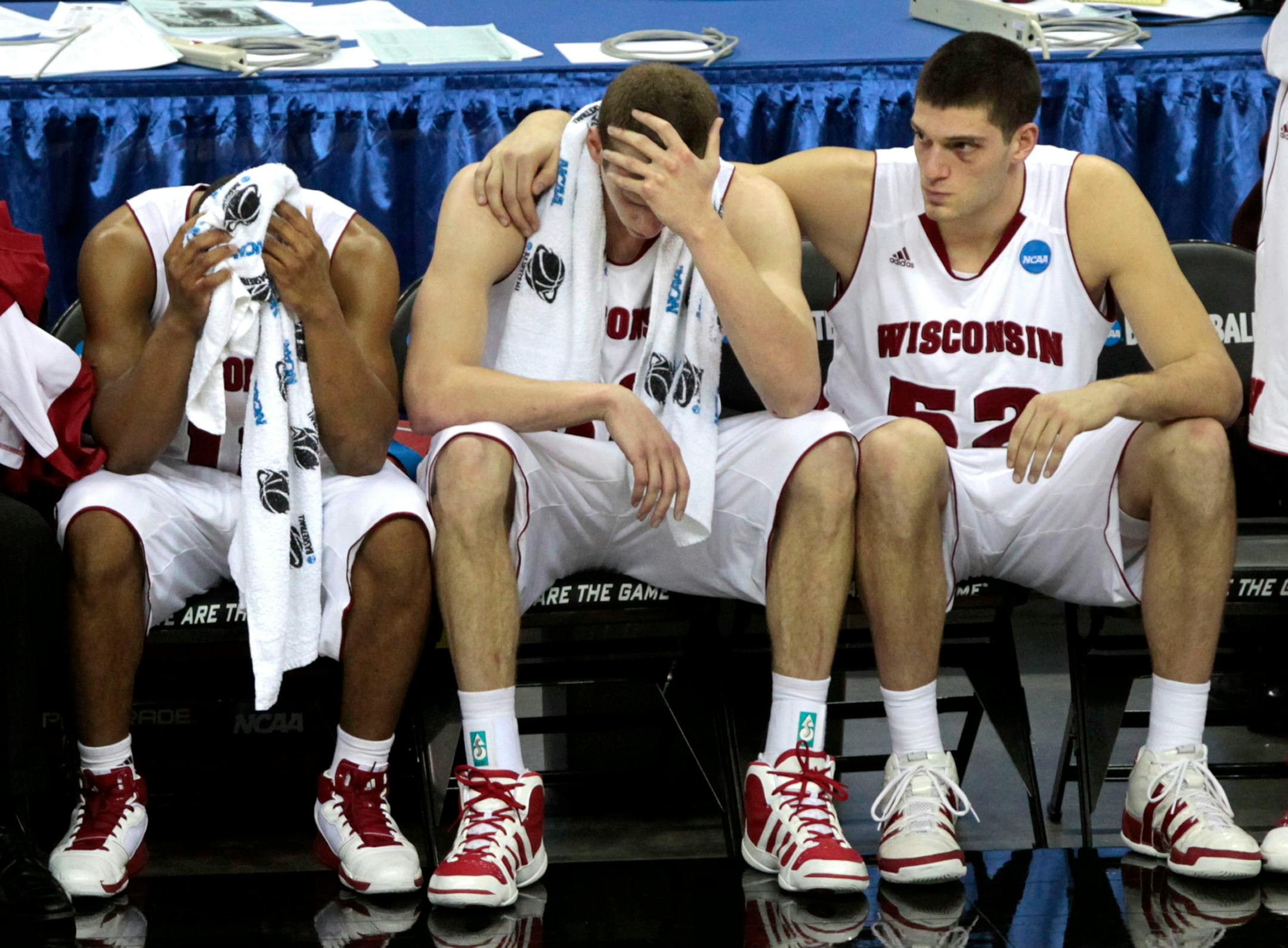 Wisconsin's Jordan Taylor (11), Jon Leuer and Keaton Nankivil (52) react on the bench during the second half of the NCAA Southeast regional college basketball semifinal game Thursday, March 24, 2011, in New Orleans. Butler won 61-54. (AP Photo/Gerald Herbert)