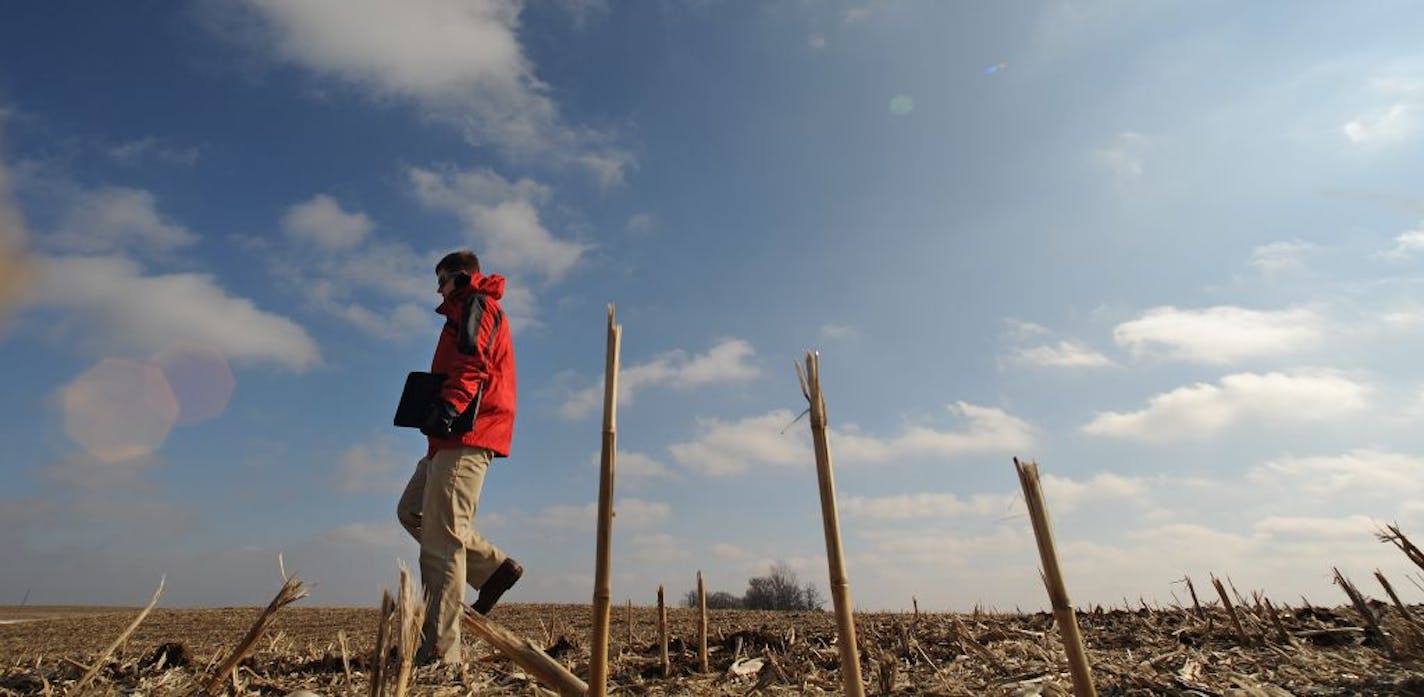 Marc Schober is in the business of vetting farms for various buyers. He tromps over frozen fields looking at soil maps and photographing the land . He spent the morning walking over two parcels of land near Hollandale, Minn.