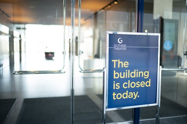 A sign at an entrance to the Guthrie Theater stated that the building was closed on Sunday.