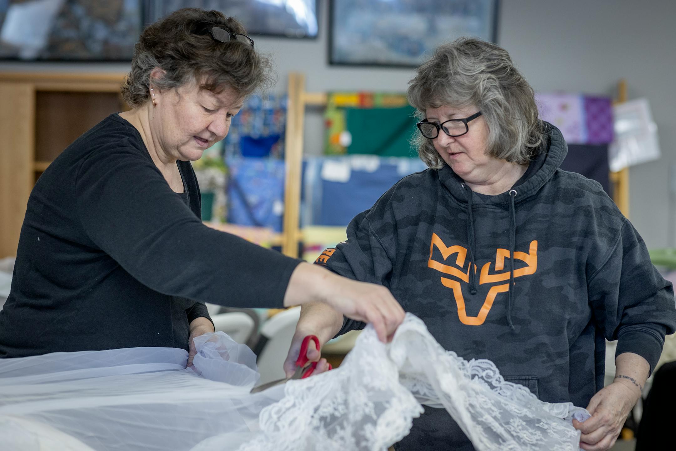 "I can't relate, but I want to make each gown special for somebody's baby," said Sharon Krueger, left, as she and Gayle Maurer, cq, cut up a dress to make "Angel Dresses" in the All Saints Lutheran Church basement in  Darwin, Minn.