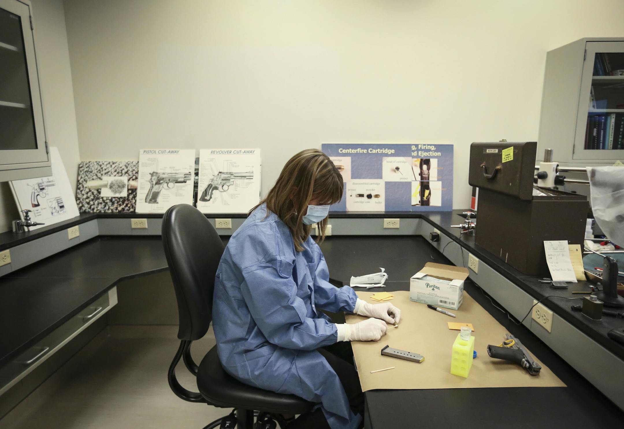 DNA supervisor Kristine Deters demonstrated how she collects DNA from firearms at the BCA in St. Paul, Minn. on Thursday, December 18, 2014. ] RENÉE JONES SCHNEIDER reneejones@startribune.com