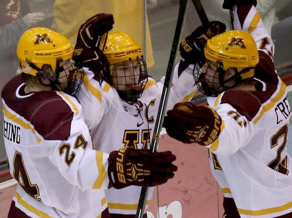 Gophers Hudson Fasting, left and Connor Reilly celebrated with Kyle Rau after scoring the overtime goal at the end of the game. ] (KYNDELL HARKNESS/ST