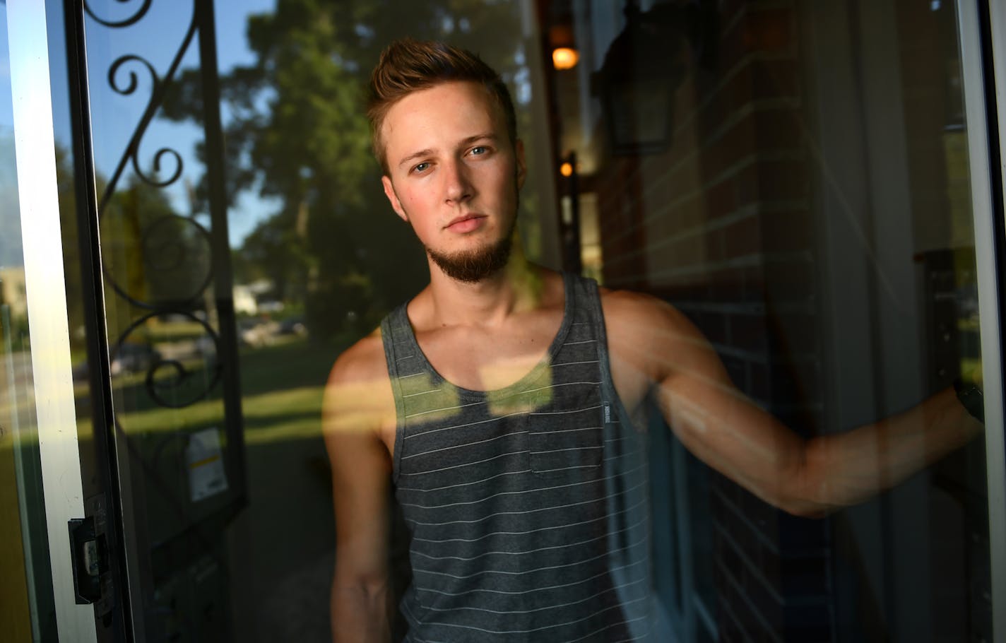 Dan Sherman, a University of Minnesota Student, stands inside his apartment complex for a portrait Thursday evening. Sherman lives across the street from where Philando Castile was shot by police. ] (AARON LAVINSKY/STAR TRIBUNE) aaron.lavinsky@startribune.com Since last Weds, Falcon Heights -- a 2-square-mile town not even big enough to have its own police force -- has been violently thrust onto the wrong side of a heated national topic. As the mayor just said the day after: &#x201c;This inciden