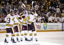 UMD forward Noah Cates (21) celebrated with his teammates after scoring the game tying goal with 31 seconds remaining in the third period.
